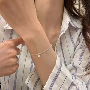 Elegant S925 sterling silver heart tassel necklace worn with a blue striped shirt