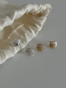 Détail des boucles d'oreilles étoile de mer en argent 925 avec nacre et bordure dorée