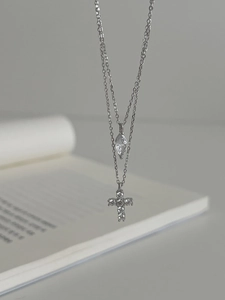 Close-up of S925 silver double layer necklace with cross and marquise drop crystal
