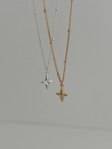 Detail of gold and silver S925 sterling silver star necklaces with sparkling zircon