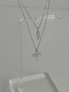 Detail view of S925 silver layered necklaces with cross and marquise stone pendants