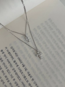 Detail of double-layer S925 silver necklace with marquise crystal and cross pendant