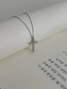 Detailed close-up of 925 sterling silver cross pendant with cubic zirconia inlay