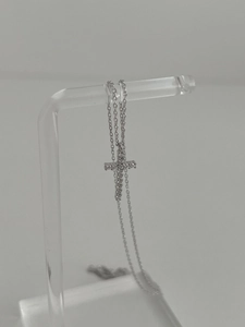 Macro detail of 925 sterling silver cross pendant with sparkling cubic zirconia inlay