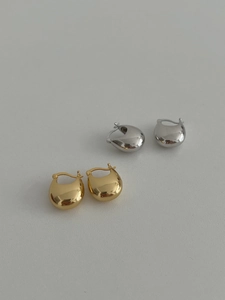 Detailed view of chunky S925 sterling silver teardrop hoop earrings in gold and silver