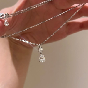 Elegant silver teardrop pendant necklace with sparkling stones on an adjustable chain