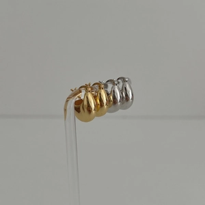 Polished S925 sterling silver drop earrings in gold and silver finish on display stand
