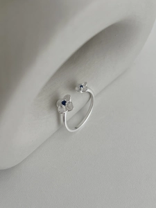 Macro shot of S925 silver flower ring featuring sparkling blue zircon stones
