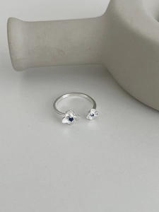Close-up of S925 silver hydrangea ring with brushed petals and blue zircon accents