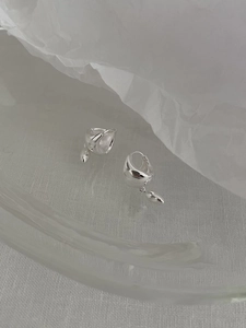Detailed macro view of S925 sterling silver hoop earrings with water drop metal pendants