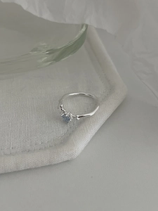 Detail of S925 sterling silver ring featuring a blue star gemstone and textured band