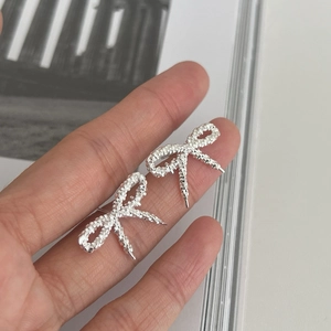 Minimalist S925 sterling silver bow earrings with textured crushed silver finish for women