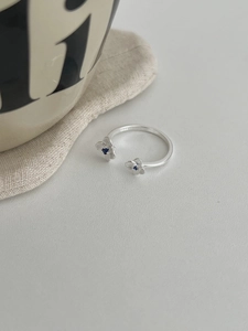Detailed view of S925 sterling silver bypass ring with blue zircon flower and hallmark