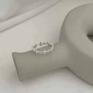 Macro detail of S925 sterling silver cross ring with pavé cubic zirconia accents