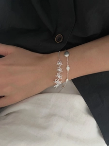 Detailed shot of S925 silver hollow daisy bracelet with crystal studs and metal discs