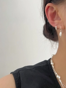Detailed view of S925 silver shell earrings and double-layer pearl necklace on a model