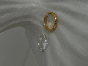 Detail of S925 sterling silver adjustable rings with vertical rib texture and small zircon