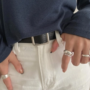 Close-up of minimalist S925 sterling silver cross ring set worn with casual outfit