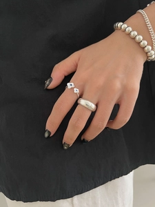 Detail of S925 silver hydrangea ring with blue zircon and layered chain bracelets