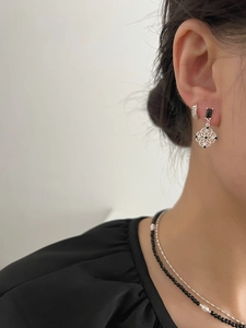 Detail showing neo-Chinese hollow window pattern earrings and layered pearl necklace set
