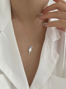 Detail of S925 silver ice cream pendant with blue crystals worn on a model