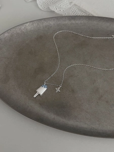 Detail of S925 silver necklace featuring a blue zircon ice cream and star pendant