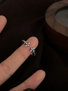 Close-up of vintage adjustable fleur-de-lis open ring with distressed silver finish