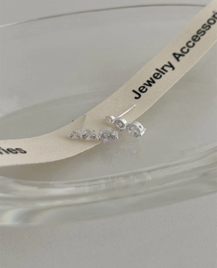 Detail of S925 silver stud earrings featuring four gradient-sized cubic zirconia stones