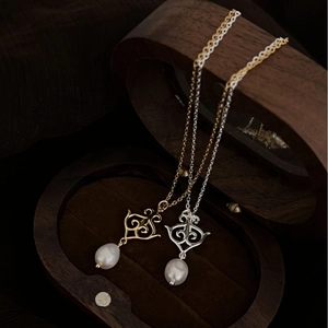 Baroque S925 silver and gold pearl necklaces with vintage pendants on velvet