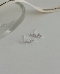 Detailed macro of S925 sterling silver three-stone gradient zircon stud earrings