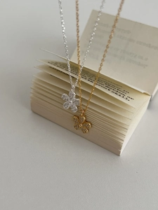 Detail of 925 silver flower pendant necklace in gold and silver with sparkling pavé stones