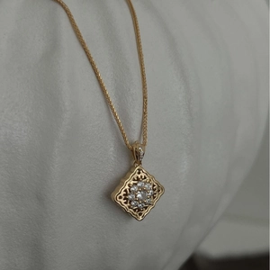 Vintage gold pillow necklace with floral hollow pendant and sparkling cubic zirconia