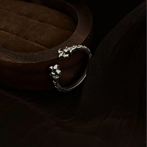 Vintage silver open ring with gothic iris flower pattern on dark wooden box