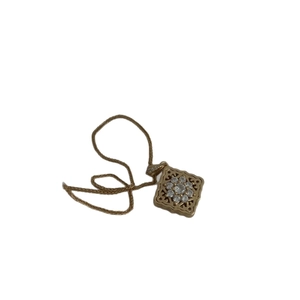 Vintage gold hollow square floral pendant necklace with crystal zircons on white background