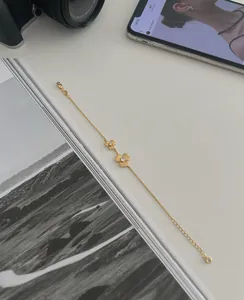 Close-up of gold flower bracelet with zircon inlays and adjustable lobster clasp closure
