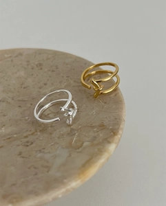 Close-up of gold and silver S925 sterling silver minimalist double-layer knot rings