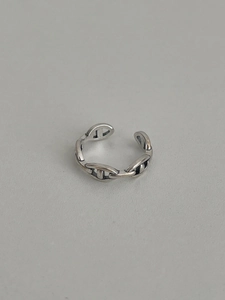 Macro detail of vintage S925 sterling silver anchor link open ring with oxidized finish