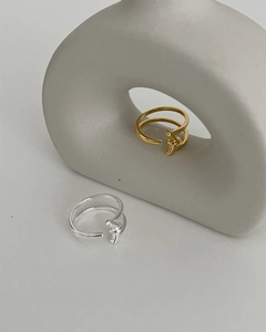 Macro view of minimalist S925 sterling silver knot rings in gold and silver finishes