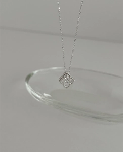 Close-up of S925 silver four-leaf clover pendant necklace with sparkling zircon details