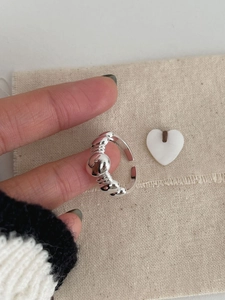 Detail of S925 sterling silver beaded ring with textured spiral band design