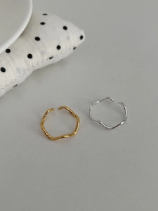 Close-up of irregular lava texture design on gold and silver S925 rings
