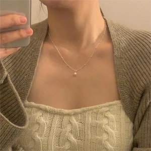 Detail of single freshwater pearl pendant on a bead chain necklace for women