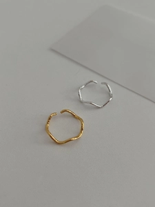 Detailed view of gold and silver S925 rings featuring irregular hammered textures