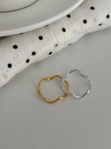 Detailed view of wavy irregular rings with silver and gold lava hammered texture