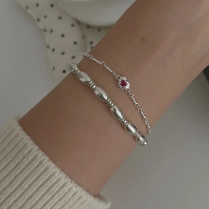 S925 sterling silver beaded bracelet set with a red ruby heart pendant on model