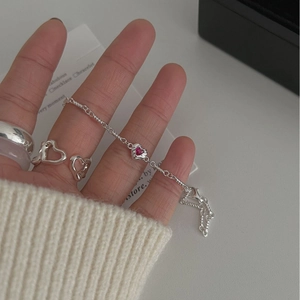 S925 sterling silver heart bracelet with pink gemstone on female model wrist