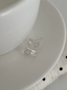 Detailed view of minimalist S925 silver stud earrings with geometric crystal and frosted ball