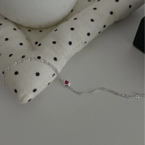 S925 sterling silver bracelet with red heart stone and angel wings on soft fabric