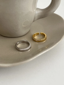 Close-up of minimalist S925 sterling silver open rings with sparkling zircon pavé