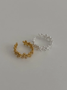 Detail of adjustable S925 silver flower rings with sparkling zircon crystals in gold and silver